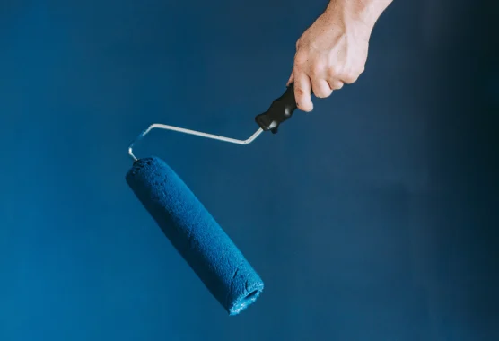 closeup-shot-female-using-paint-rollers-with-color-blue-scaled.webp